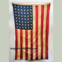 Large (approximately 69" X 44") printed linen WWII era U.S. flag.   Brass grommets. Some discolorati