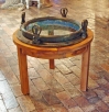 Custom made nautical table produced using an early 20th century brass four dog ship's porthole and m